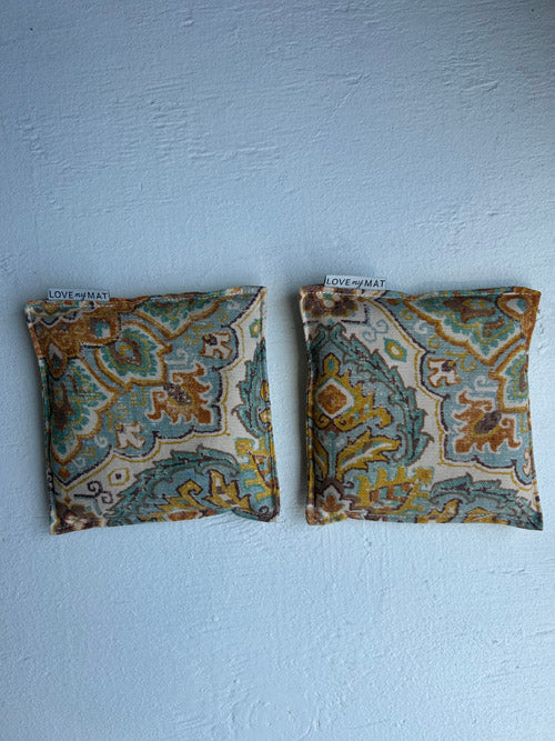 Two patterned fabric samples on a light blue background
