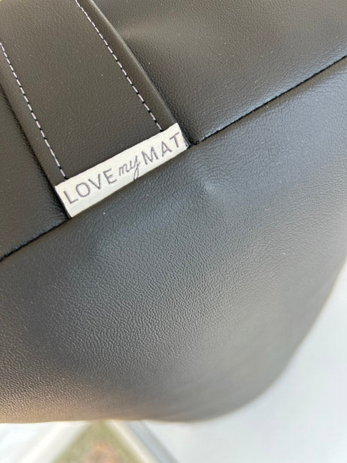 Black vinyl yoga bosltervwith 'LOVE my MAT' tag