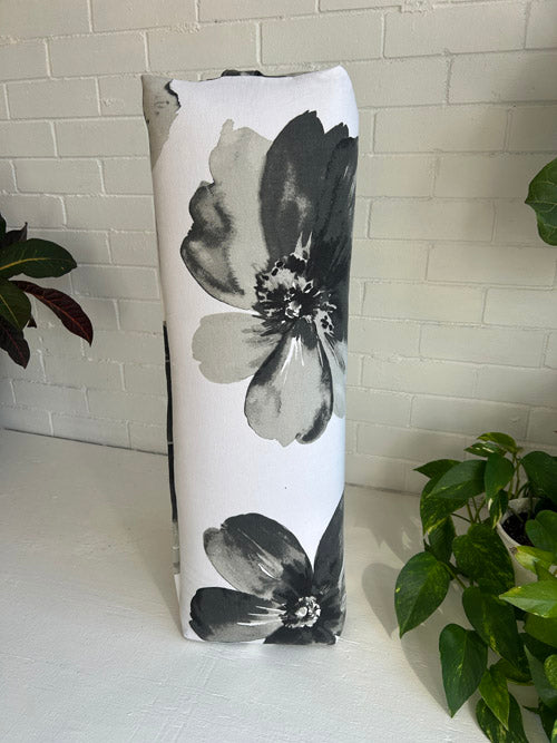 Yoga Bolster with black floral design on a white background