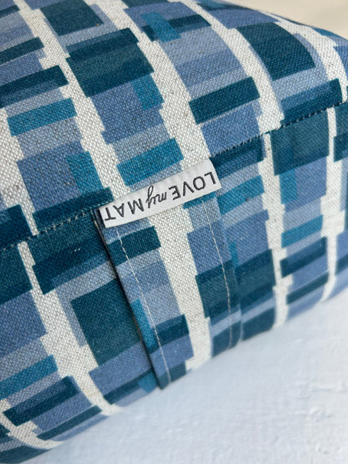 Blue checkered long yoga bolster with 'LOVE my MAT' label on a white background
