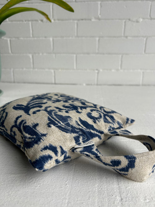 5lb Sandbag with blue floral pattern laying on a white surface