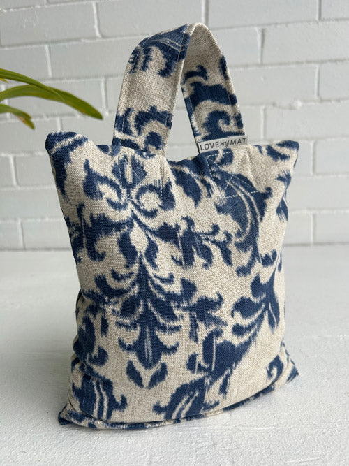 Blue and white patterned fabric sandbag with 'LOVEMYMAT' branding on a white surface.