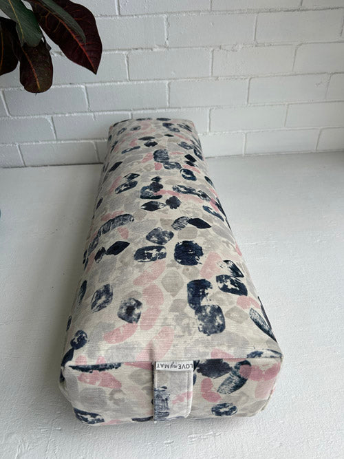 Canada made long Yoga Bolster with abstract pattern on a white surface