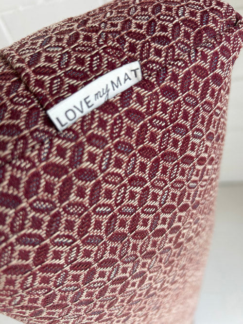 Textured yoga bolster with 'LOVE my MAT' label on a white background