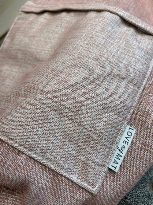 Close-up of a brown/pink fabric yoga bag with a 'LOVE MAT' label.
