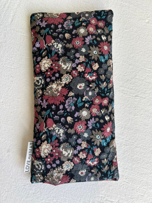 Floral patterned eye pillow on a white background
