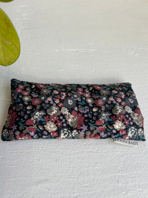 Floral patterned eye pillow on a light gray background