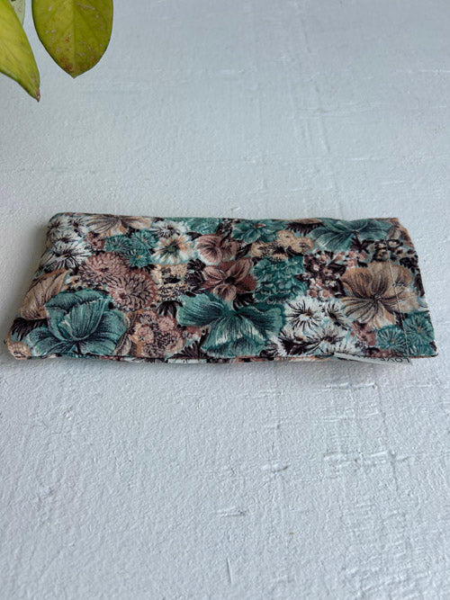 Floral patterned eye pillow on a white background
