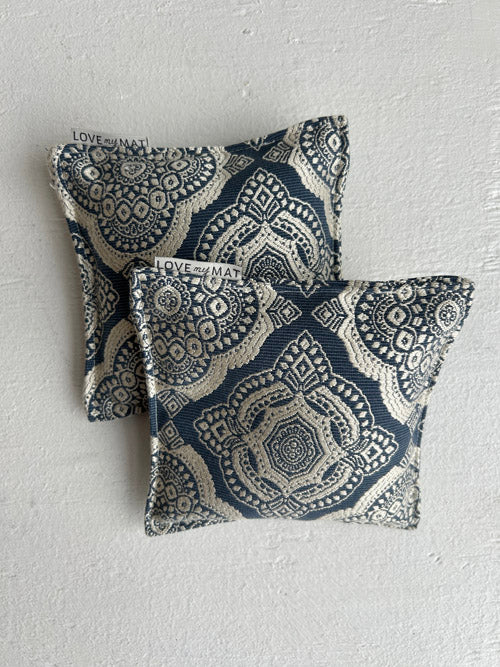 Blue and Cream pattern yoga knee pillows on a white background