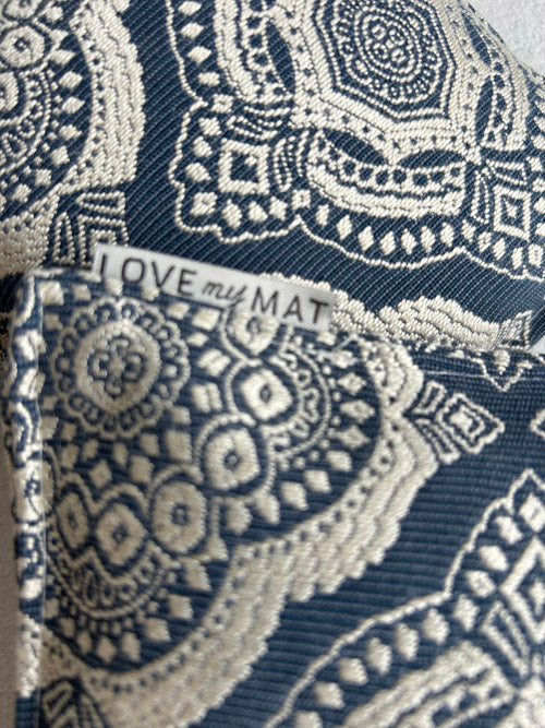 close up of yoga knee pillows in a blue and cream geometric pattern