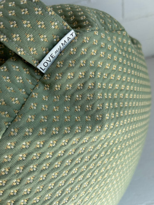 Green textured floor cushion with 'LOVE my MAT' label on a white background