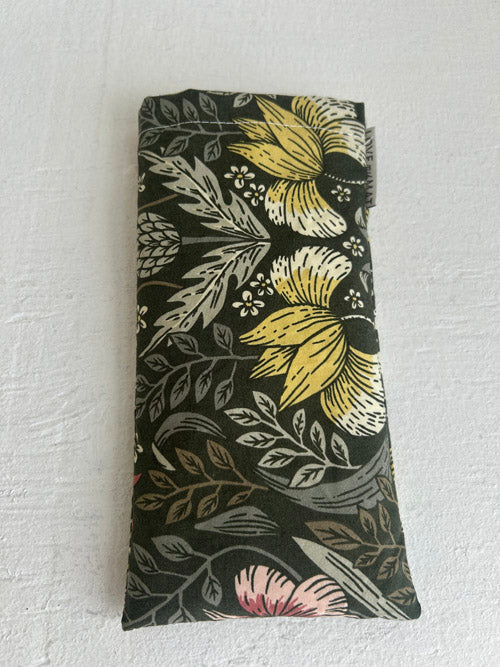 Fabric Eye Pillow with floral pattern on a textured white surface