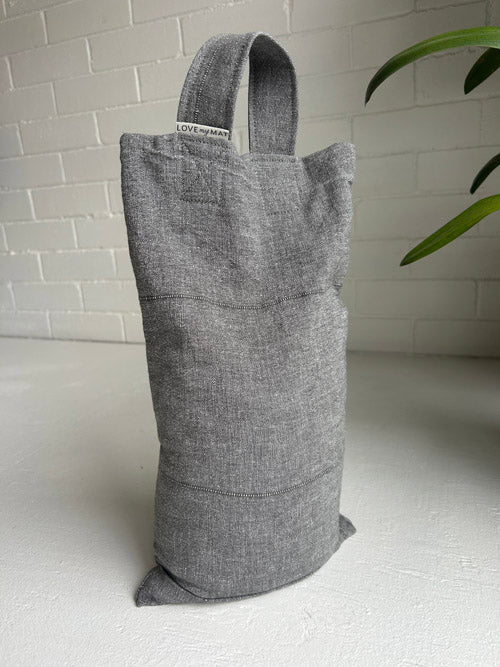 Gray 10 lb sandbag bag with a visible brand label on a white surface.