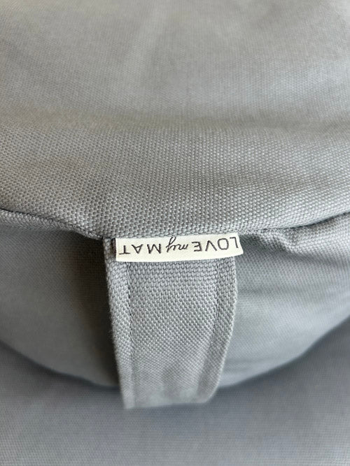 Gray fabric with a visible brand label on a gray background