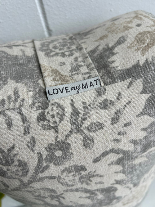 Patterned bolster with 'LOVE my MAT' label on a white background