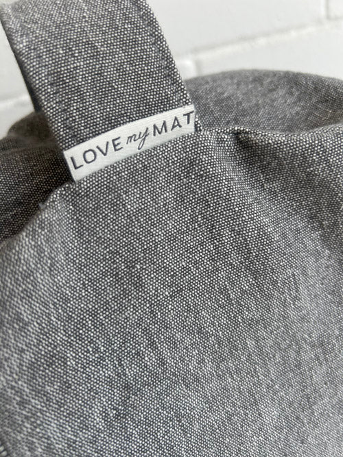 Gray textured fabric floor cushion with 'LOVE my MAT' label on a white background