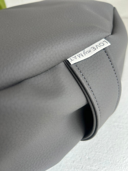 Gray Vinyl floor cushion with a visible brand logo on a light gray background