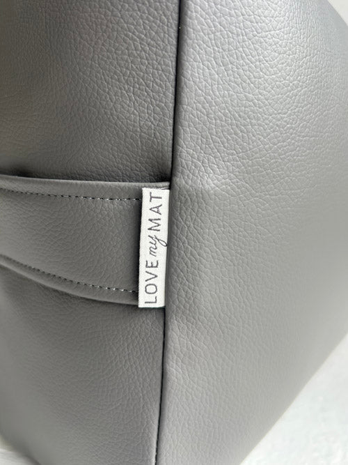 Close up of a vinyl yoga bolster with 'LOVE MY MAT' label