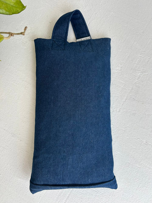 Blue denim sandbag on a light gray background