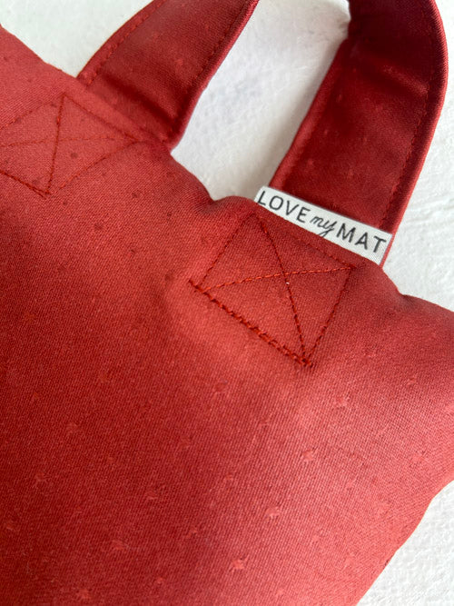 Red fabric  sandbag with 'LOVE my MAT' label on a white background