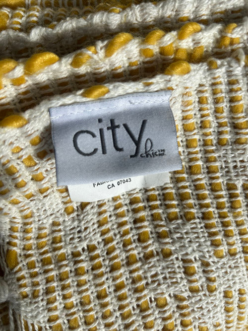 Close-up of fabric with a 'city' label on a textured background