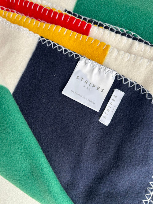 Colorful fabric with a 'Stripes' label on a green background