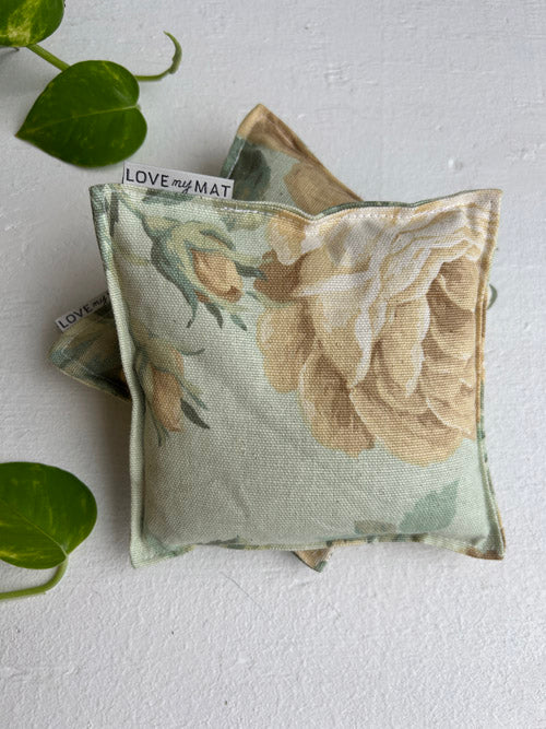 Floral-patterned yoga knee pillows with 'LOVE my MAT' label on a white background