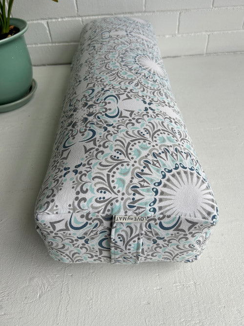 Yoga Bolster with a floral pattern on a white surface