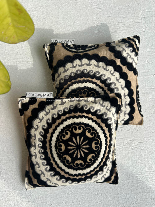 Two black and white patterned knee pillows on a light gray surface with 'LOVE MY MAT' branding.