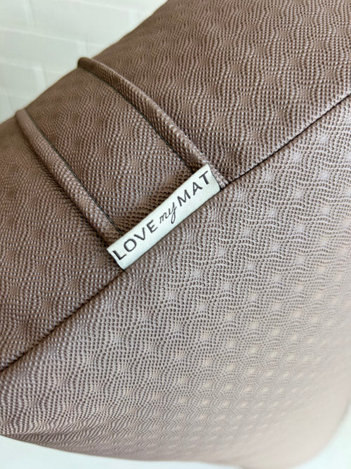 Mauve textured long yoga bolster with 'LOVE my MAT' label on a white background
