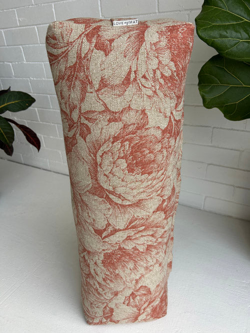 Floral patterned yoga bolster long on a white surface