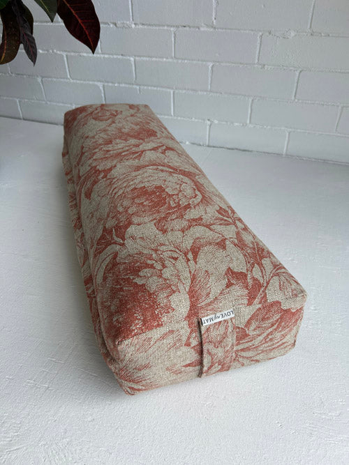 Yoga Bolster with floral pattern on a white surface