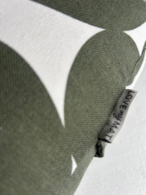 Close-up of a green fabric with a label on a white background