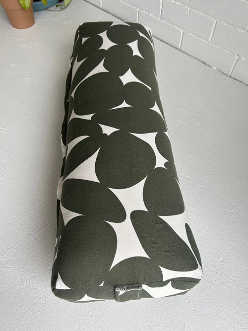 Black and white patterned fabric roll on a light gray surface