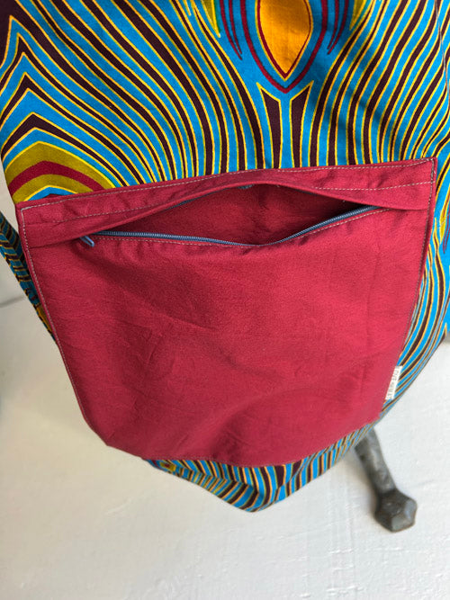 Colorful fabric with a red pocket on a white background