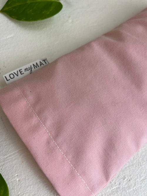 Pink eye pillow with 'LOVE MY MAT' label on a white background