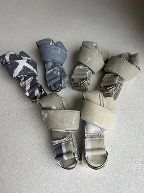 Set of Yoga Straps in various colors on a light gray background