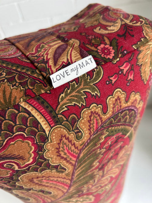 Decorative yoga block with paisley pattern and 'LOVE my MAT' label on a white background