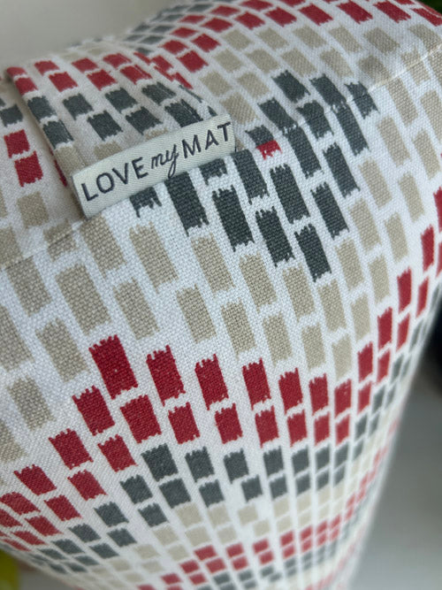 Close up of yoga bolster with a geometric pattern and 'LOVE my MAT' label.