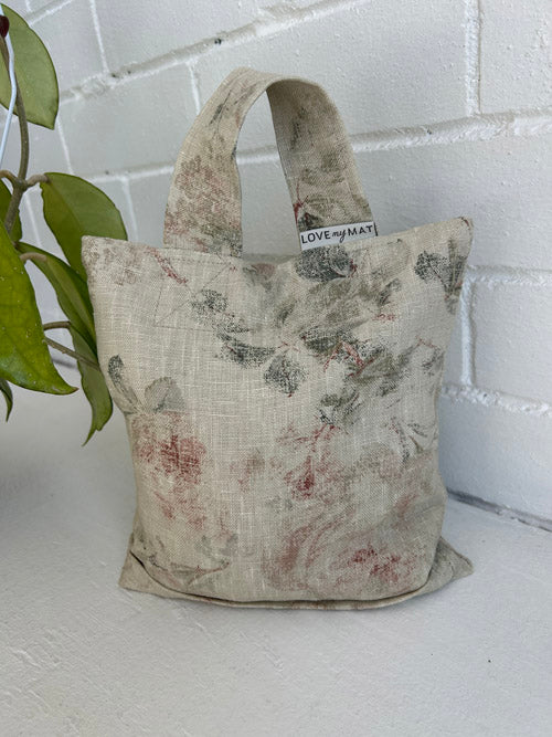 Floral-patterned fabric sandbag bag with 'LOVE my MATT' label on a white surface.