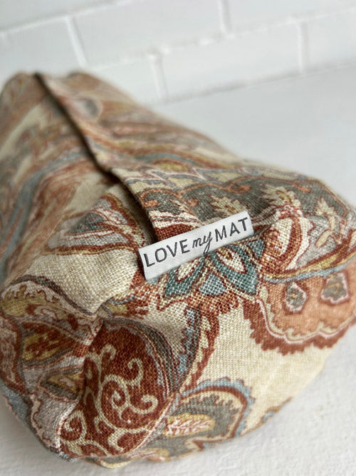 Patterned yoga round bolster with 'LOVE my MAT' tag on a white background