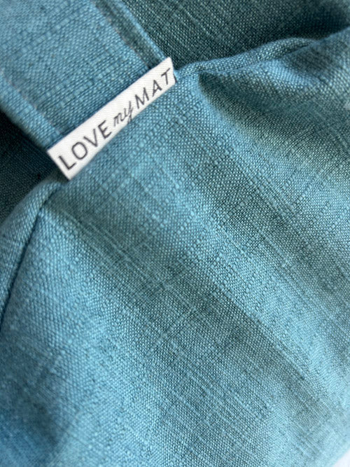 Teal Sit Pillow with a 'LOVE my MAT' tag