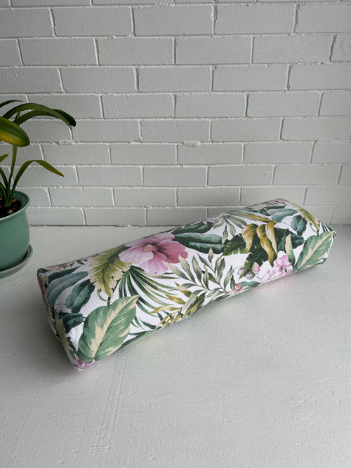 Tropical patterned Yoga Bolster on a white surface and against a white background