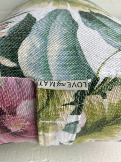 Close up of a Tropical Patterned Yoga Bolster on a white surface