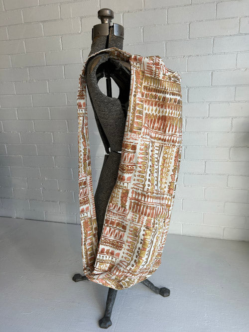 Vintage looking fabric yoga mat bag on a mannequin with a white background