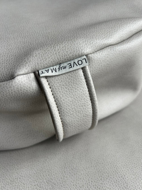 Gray vinyl product with a visible brand tag on a gray background