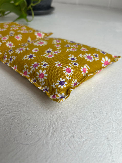 Floral-patterned fabric yoga knee pillows on a white surface