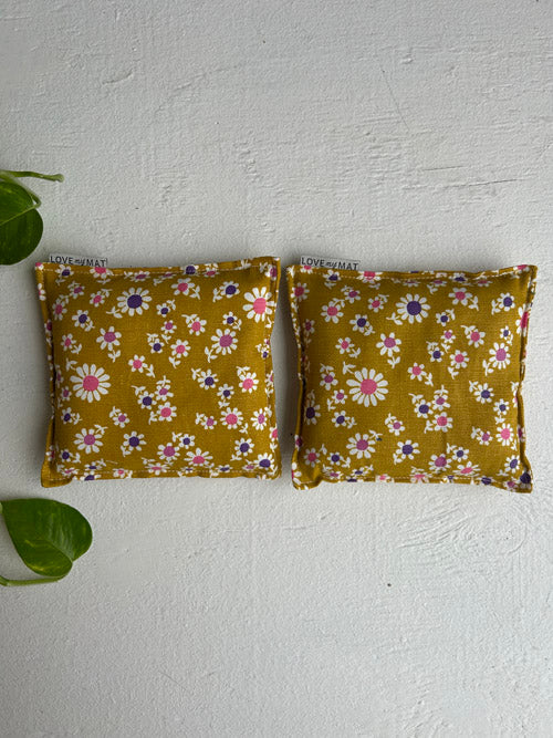 Two floral-patterned yoga knee pillows on a white background